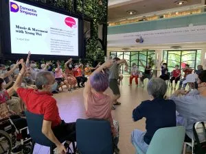 Persons with dementia and caregivers enjoying performing arts activities at Memories Café